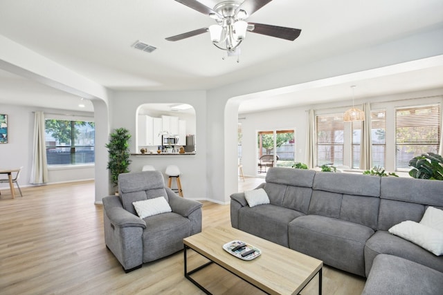 living room featuring ceiling fan and light hardwood / wood-style floors