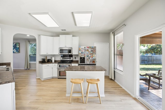 kitchen featuring a wealth of natural light, light hardwood / wood-style flooring, and appliances with stainless steel finishes