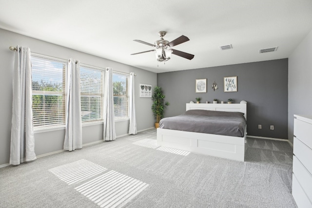 bedroom featuring ceiling fan and light carpet