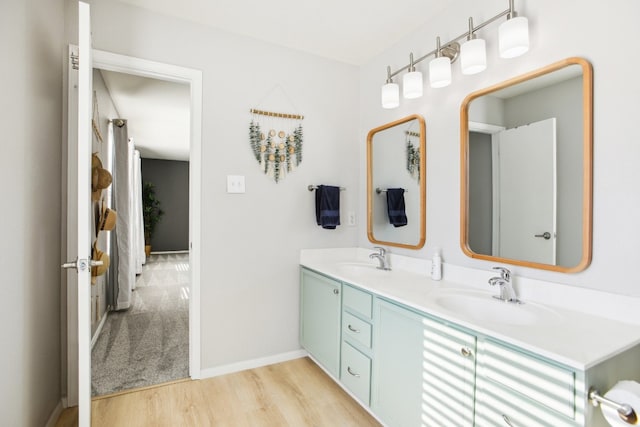 bathroom with hardwood / wood-style flooring and vanity