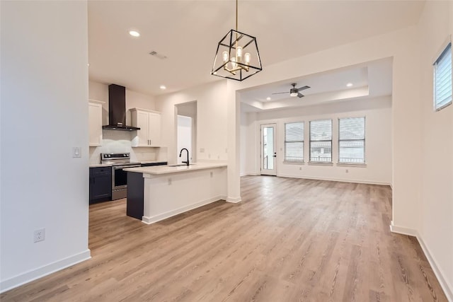 407 Meadowlark St, Austin, TX 78734 - kitchen featuring wall chimney exhaust hood, stainless steel electric range, open floor plan, recessed lighting, and healthy amount of natural light