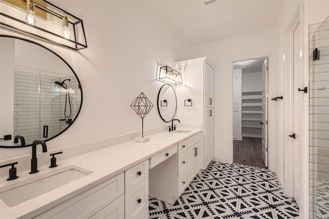 bathroom featuring vanity, an enclosed shower, and tile patterned flooring