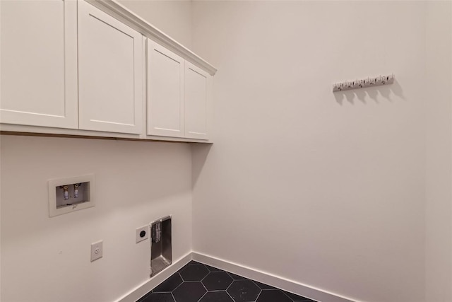407 Meadowlark St, Austin, TX 78734 - laundry area featuring cabinet space, hookup for an electric dryer, washer hookup, and dark tile patterned floors