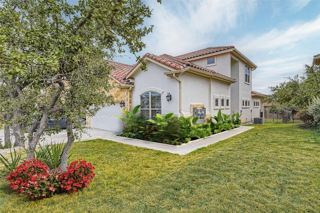 view of side of property with central AC unit, a garage, and a yard