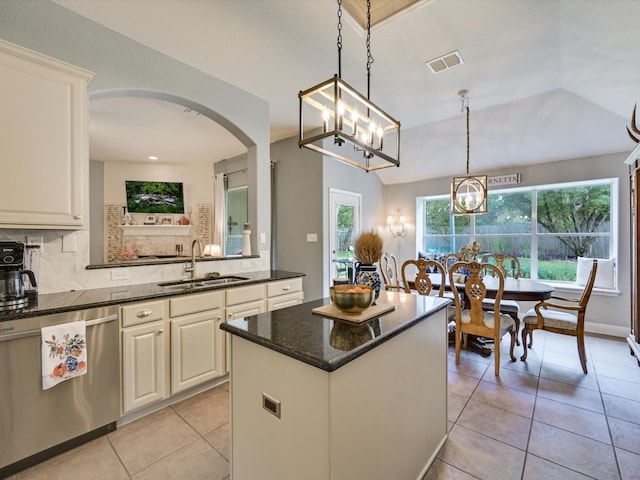 kitchen featuring sink, tasteful backsplash, hanging light fixtures, a kitchen island, and dishwasher