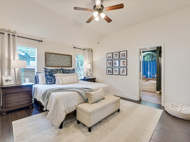 bedroom with hardwood / wood-style floors, multiple windows, and connected bathroom