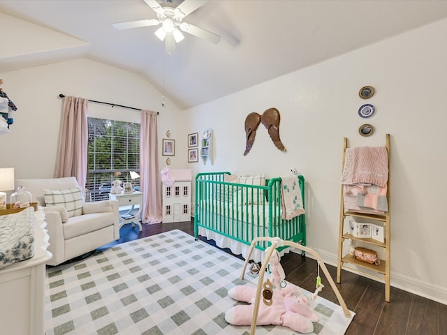 bedroom featuring dark wood-type flooring, vaulted ceiling, and ceiling fan