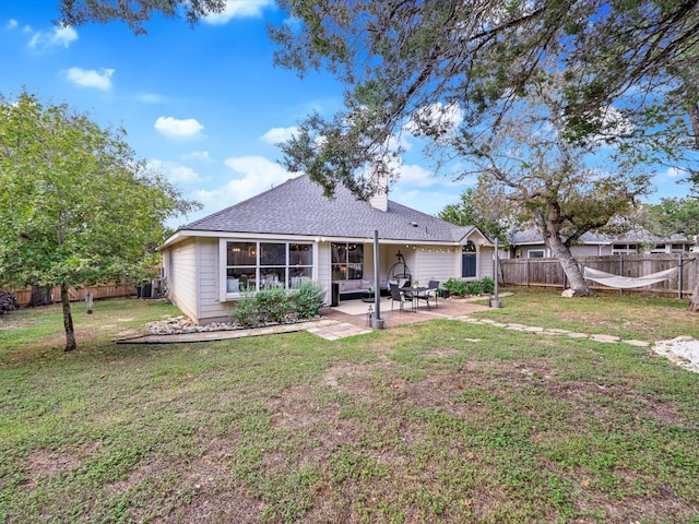 back of property featuring a yard and a patio area