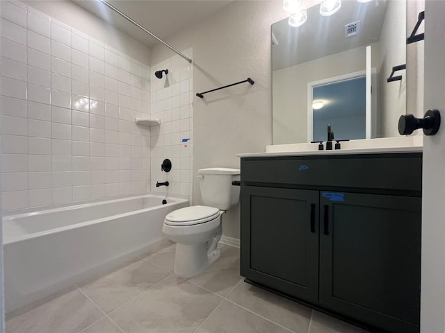 full bathroom featuring vanity, tile patterned flooring, toilet, and tiled shower / bath