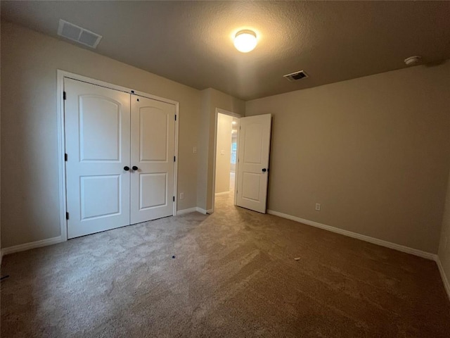 unfurnished bedroom with a closet and carpet