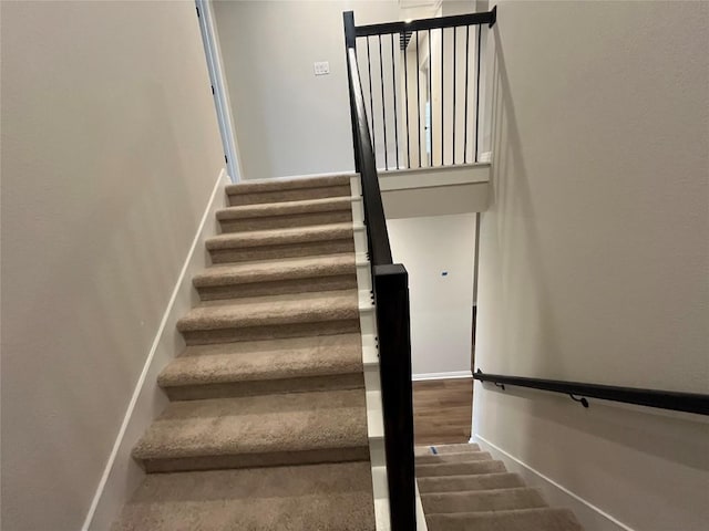 stairway with hardwood / wood-style floors