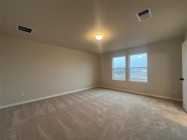 unfurnished room with light carpet