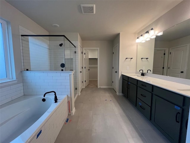 bathroom with shower with separate bathtub and vanity