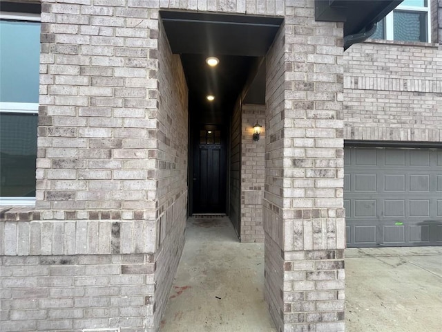 doorway to property with a garage