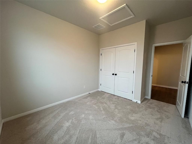 unfurnished bedroom featuring light colored carpet and a closet