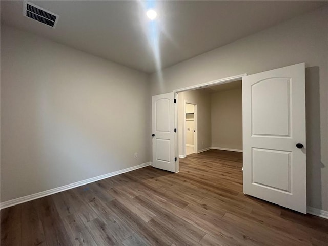 unfurnished bedroom with wood-type flooring