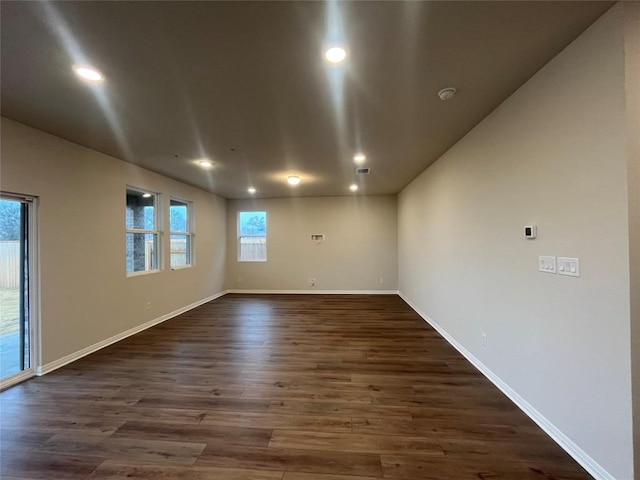 spare room with dark wood-type flooring