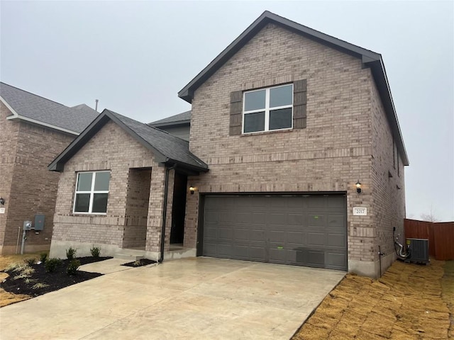 view of front of home featuring a garage and central air condition unit