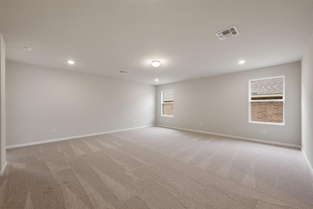 empty room featuring light carpet