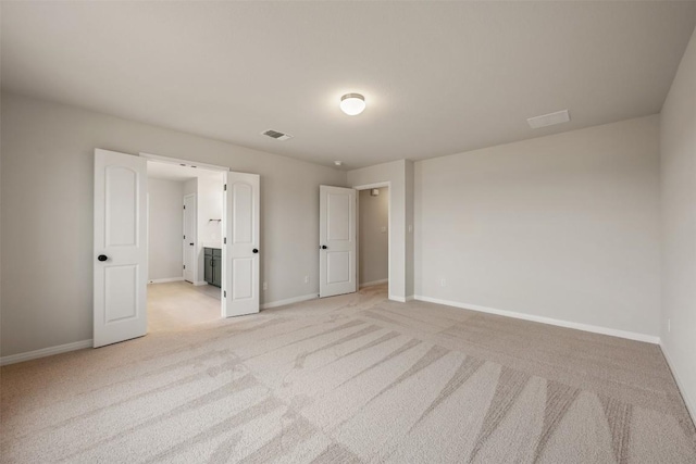 unfurnished bedroom featuring light colored carpet