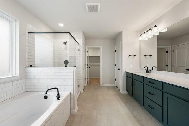 bathroom with vanity and separate shower and tub