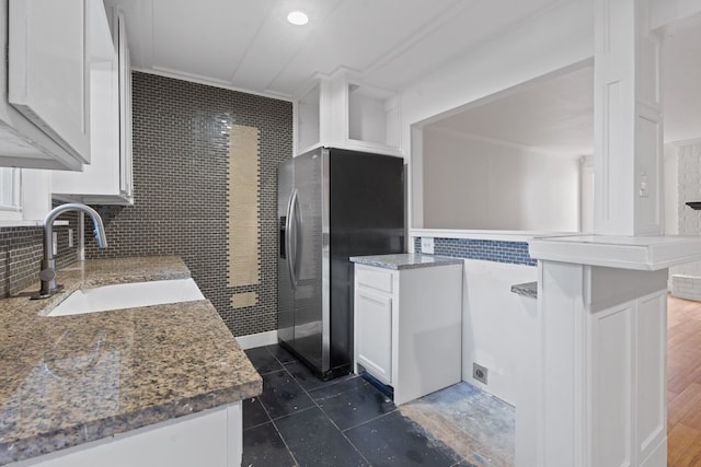 kitchen featuring dark hardwood / wood-style flooring, sink, tasteful backsplash, stainless steel fridge with ice dispenser, and white cabinetry