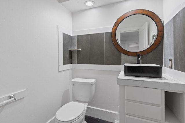 bathroom featuring toilet, vanity, and tile patterned flooring