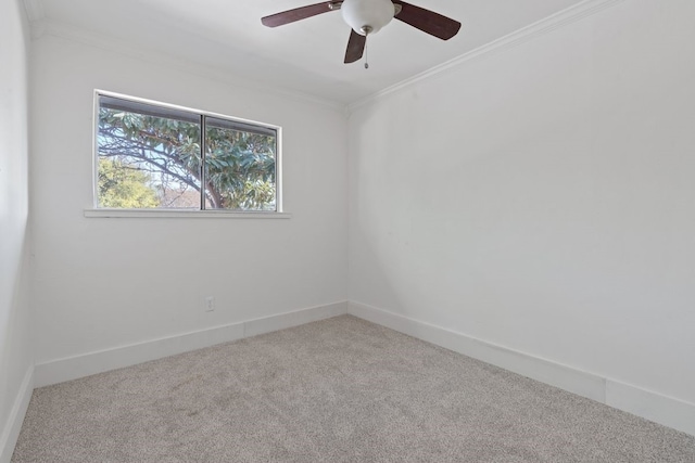 carpeted empty room with ceiling fan and crown molding