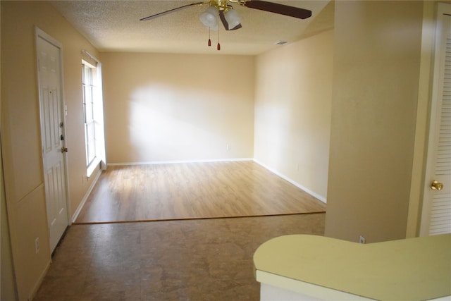 entryway with hardwood / wood-style floors, ceiling fan, and a textured ceiling