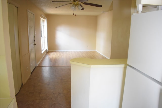 entrance foyer with a textured ceiling, hardwood / wood-style flooring, and ceiling fan