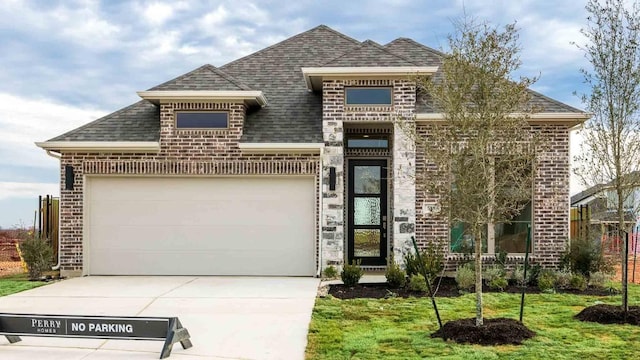 view of front facade with a garage and a front yard