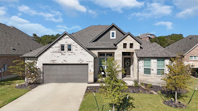 view of front of property featuring a front yard and a garage