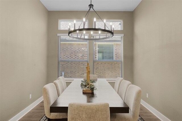 dining area featuring hardwood / wood-style floors and a chandelier