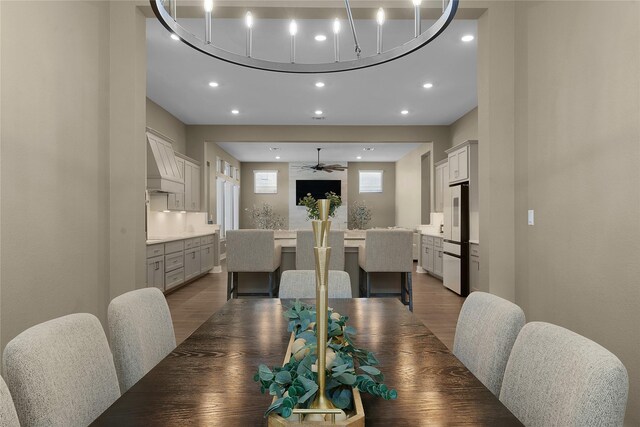 dining space featuring ceiling fan, a healthy amount of sunlight, and dark hardwood / wood-style floors