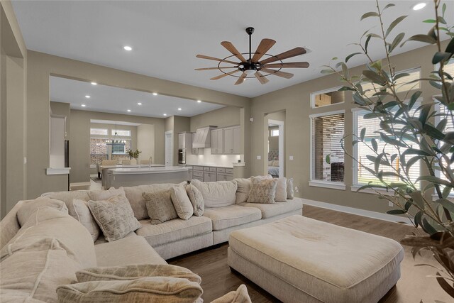 living room with sink, ceiling fan, and hardwood / wood-style flooring