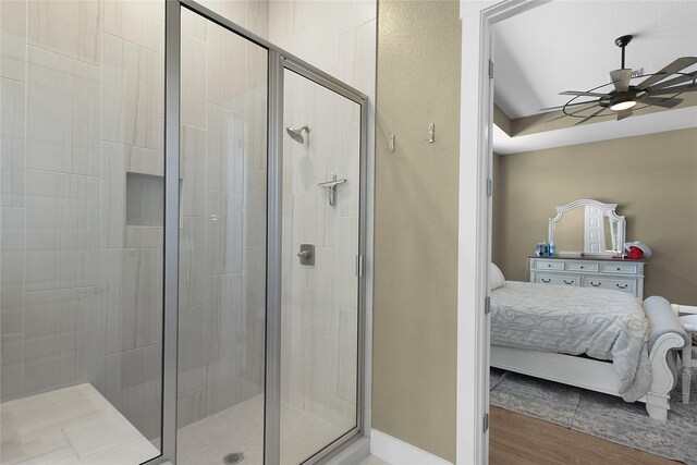 bathroom featuring ceiling fan, wood-type flooring, and walk in shower