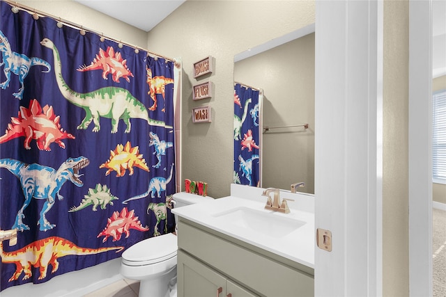 bathroom with curtained shower, toilet, and vanity