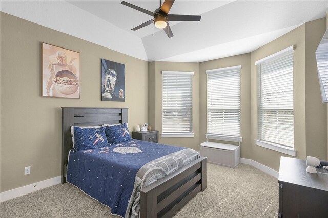 carpeted bedroom with ceiling fan, vaulted ceiling, and multiple windows