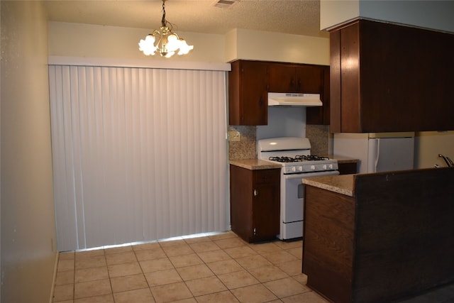 kitchen featuring hanging light fixtures, a chandelier, tasteful backsplash, dark brown cabinets, and white appliances