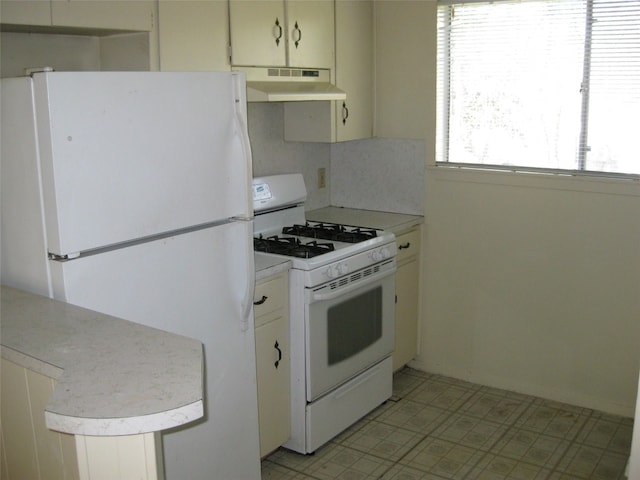 kitchen with white cabinets and white appliances