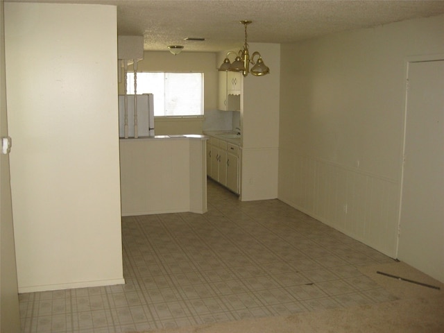 unfurnished room featuring a textured ceiling