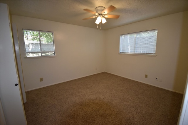 carpeted empty room featuring a textured ceiling and ceiling fan