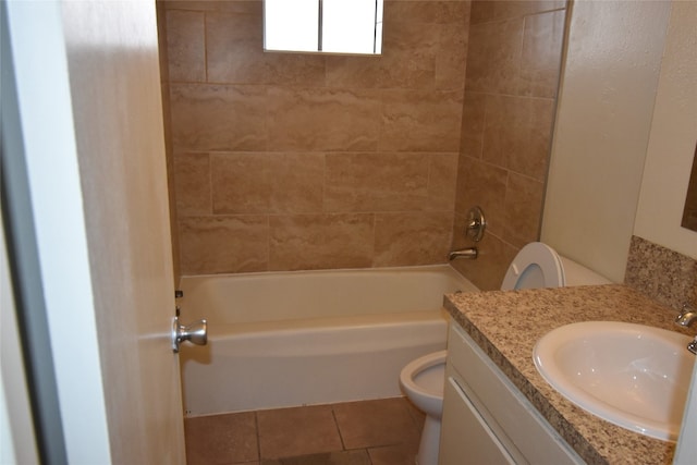 full bathroom with toilet, vanity, tiled shower / bath, and tile patterned floors