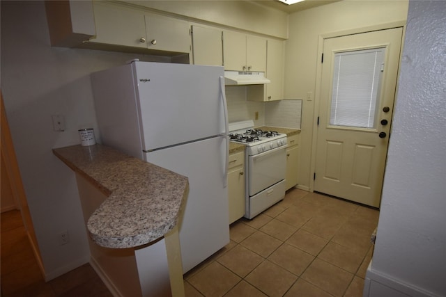 kitchen with white cabinetry, light tile patterned floors, and white appliances