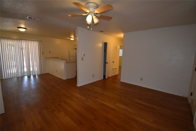 unfurnished living room with a textured ceiling, hardwood / wood-style flooring, and ceiling fan