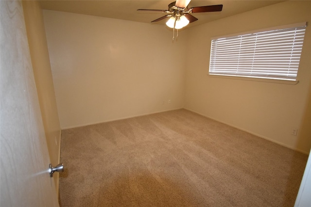 carpeted spare room with ceiling fan