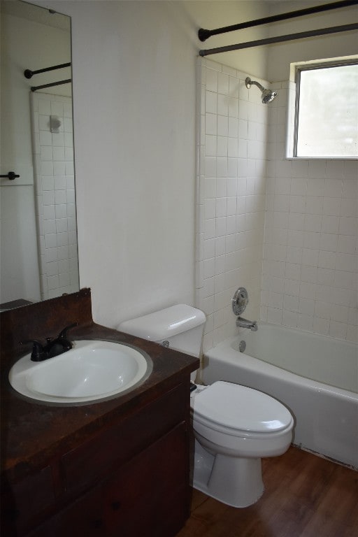 full bathroom with wood-type flooring, vanity, toilet, and tiled shower / bath combo