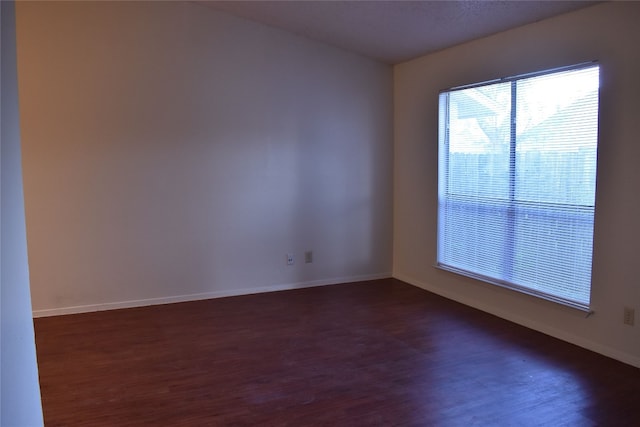 spare room featuring dark hardwood / wood-style floors