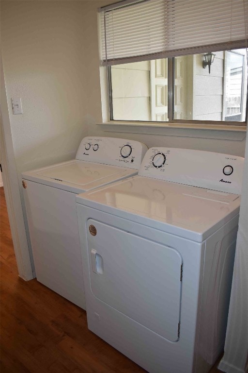 laundry room with hardwood / wood-style floors and independent washer and dryer