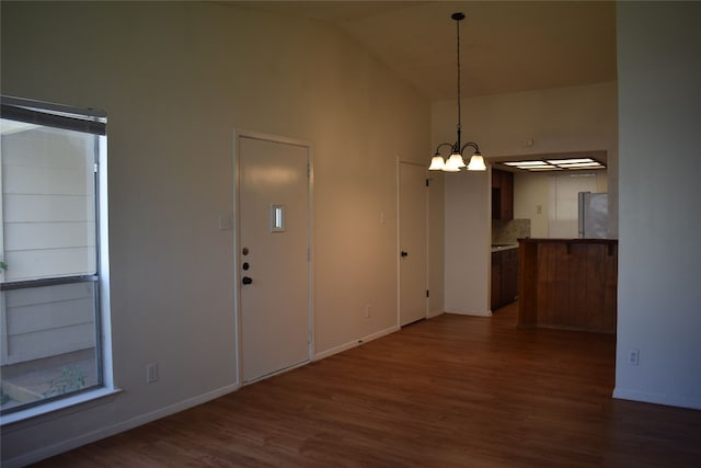 interior space with high vaulted ceiling and dark hardwood / wood-style floors